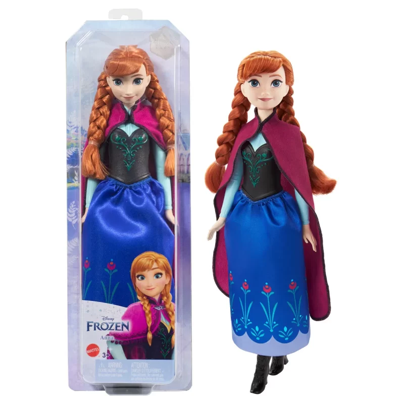 Disney Frozen Core Anna Frozen 1 - Anna-dukke, der kan poseres, i sin ikoniske rejsestil med kappe, nederdel og sko. Perfekt til børn fra 3 år til at genskabe Frozen-eventyr.