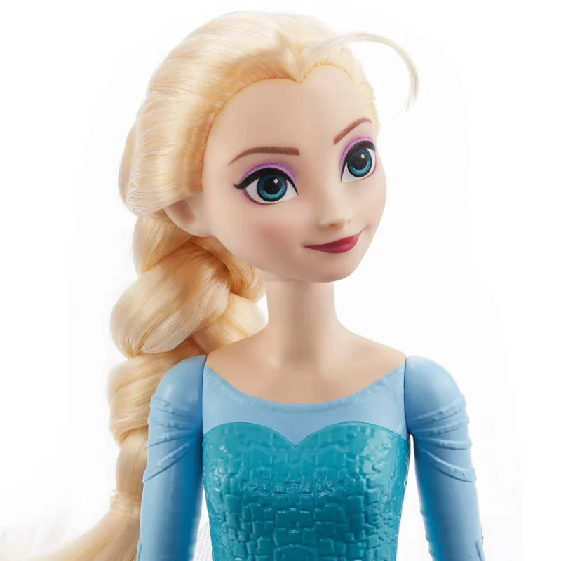 Disney Frozen Core Elsa Frozen 1 - Elsa-dukke, der kan poseres, i sit ikoniske outfit fra Frozen. Indeholder kappe, nederdel og sko. Ideel til børn fra 3 år.
